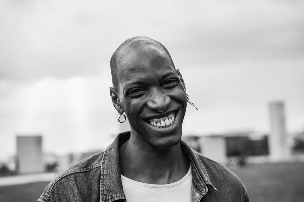 Happy african man smiling on camera outdoor - Focus on face - Black and white editing